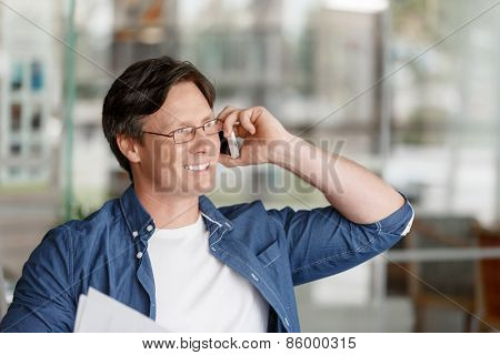 Handsome young businessman talking over phone