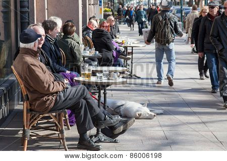Helsinki, Finland - March 29:the People Having A Rest Behind A Little Table Of Street Cafe Of Helsin