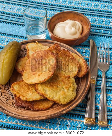 Traditional Ukrainian Homemade Potato Pancakes (draniks) A Glass Of Vodka And Salted Cucumber