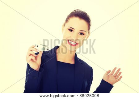Young businesswoman with plane toy in hand