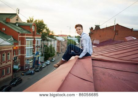 Happy Hipster On The Edge Of The Roof