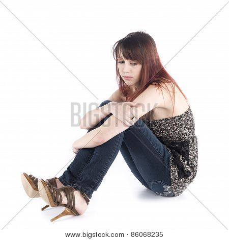 Sad Woman Sitting on the Floor Embracing her Knee
