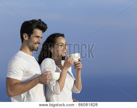 happy young romantic couple have fun relax smile at modern home outdoor terace balcony terace