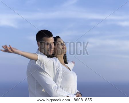 happy young romantic couple have fun relax smile at modern home outdoor terace balcony terace