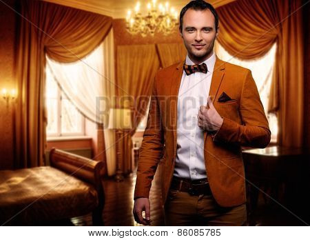 Sharp dressed dandy fashionist in luxury apartment interior 