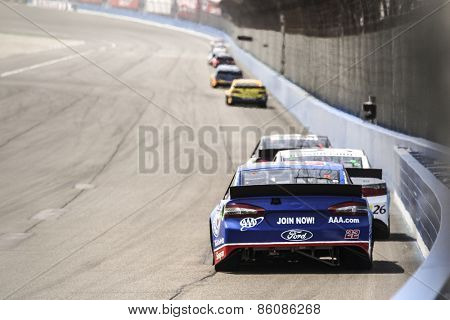 Fontana, CA - Mar 22, 2015:  Joey Logano (22) brings his race car through the turns during the  race at the Auto Club Speedway in Fontana, CA.