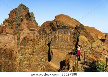 Young girl on the winding mountain trekking path at Pico do Areeiro, Madeira, Portugal
