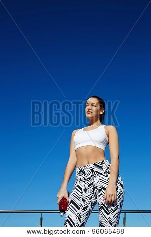 Healthy woman with beautiful figure enjoying sunny afternoon during her daily workout training