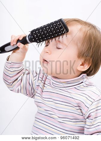 Cute Little Baby Playing With A Hairbrush
