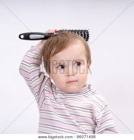 Cute Little Baby Playing With A Hairbrush
