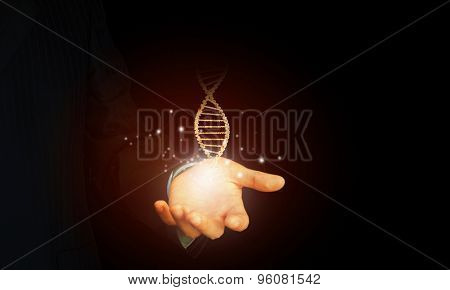 Close up of man holding DNA molecule in palm
