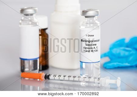 Close-up Of Meningococcal Vaccine With Syringe And Medicines