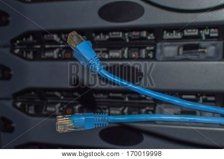 Two blue internet background patchcords on computer servers