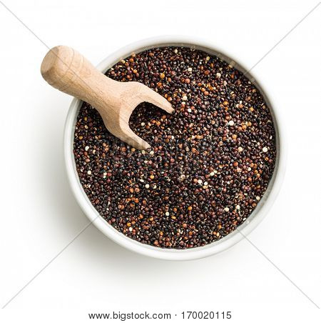 Black quinoa seeds in bowl with wooden scoop isolated on white background. Top view.