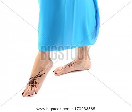 Female legs with henna tattoo, isolated on white