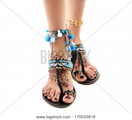 Female legs with henna tattoo, isolated on white