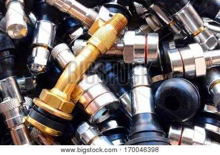 A top view image of several metal valve stems.