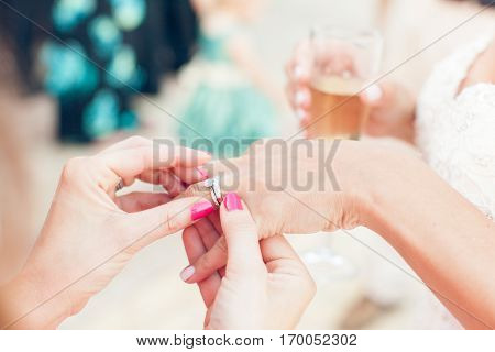 Bride shows wedding ring to girlfriend close-up