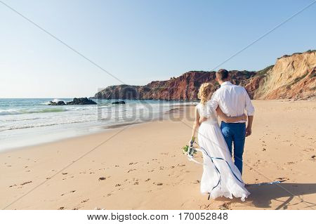 The bride and groom on beautiful beach near Ocean