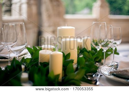 Candles and goblets on a decorated wedding table close-up
