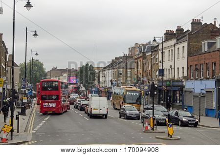 LONDON UK - SEPTEMBER 17 2016: Busy traffic and pedestrials using the famous Tottenham High Road on a cloudy day in North London.