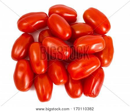 Small red oblong tomatoes on plate. Studio Photo