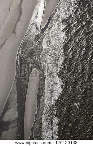 Aerial view of the shore with shapes lines and patterns formed by the waves on the sand Ameland islad Friesland The Netherlands