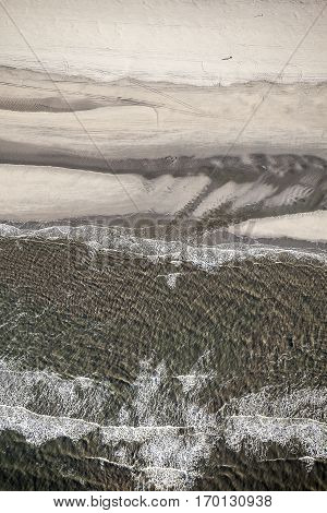 Aerial view of the shore with shapes lines and patterns formed by the waves on the sand Ameland islad Friesland The Netherlands
