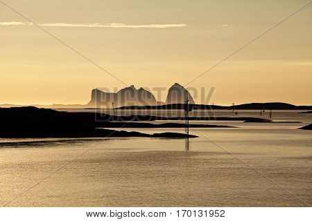 Midnight sun Norwegian Landscape with the mountain shape of Traena Island