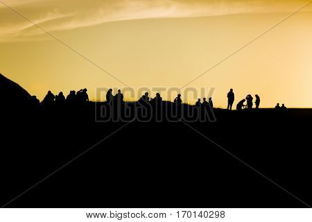 Traena festival 2014 people standing on the top of a hill dmiring the midnight sun