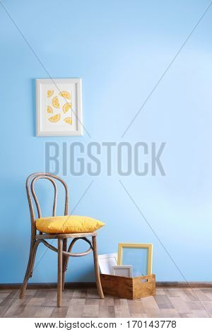 Simple interior with stool and painting on blue wall background