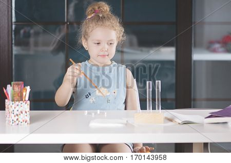 a Caucasian child spends chemical experiences in class room