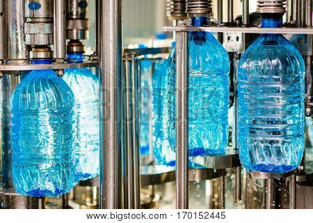 Filling pure bottles with mineral water at a factory