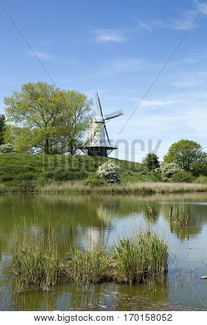 Typical Dutch landscape with a canal and a windmill, Molen de Koe, Veere, The Netherlands