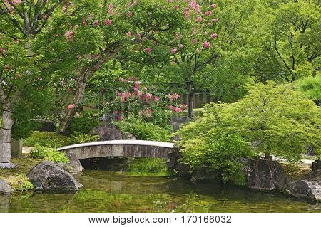 Japan, Himeji, Himeji Koko-en Gardens, stone bridge over stream