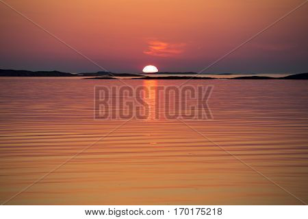 Orange tone Norwegian landscape in the midnight sun