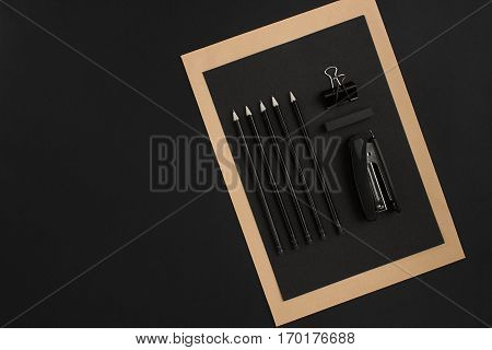 Mix of office supplies on a modern office desk. Object on a black background. Top view. Still life. Copy space