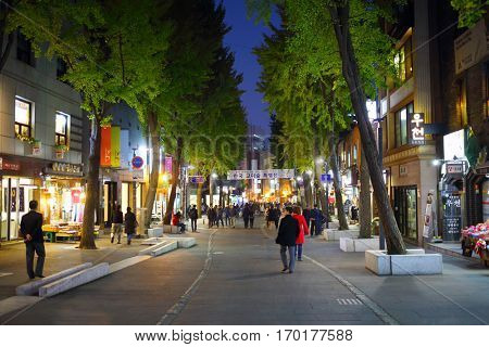 SEOUL - NOV 2, 2015: People walk on street among markets at night. South Korea has overtaken China in popularity among Russian tourists
