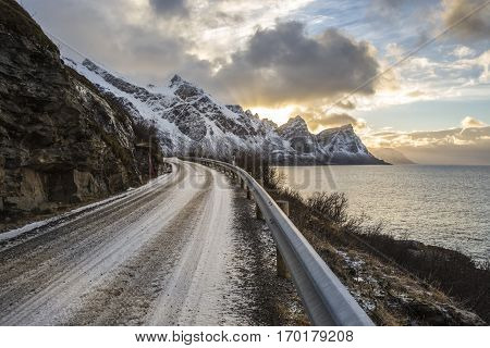 Norwegian landscape with a tiny road along the seaside in a fjord in the winter Nordland Norway
