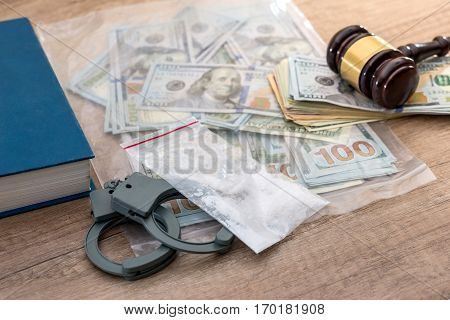 Drugs and substances prohibited dollar book Judge gavel and handcuffs - arrest criminals