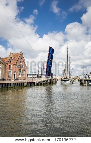 Noorderhaven canal with boats open bridge and houses in historic old town of Harlingen Friesland Netherlands