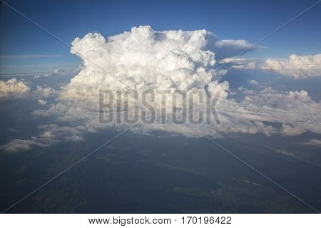 Close up on white fluffy storm clouds in front of blue sky