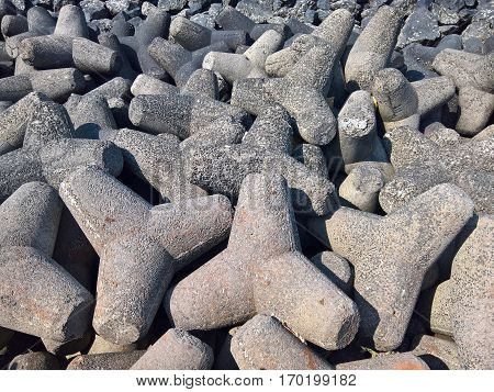 A bunch of concrete tetrapods along the ocean front.