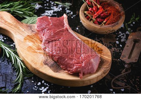 Raw Steak With Herbs And Pepper