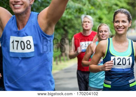 Marathon male athlete crossing the finish line in park