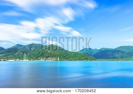 scenic view of the harbour with mountain background against cloudy sky at Bang-Bao Koh Chang Island (Thailand).