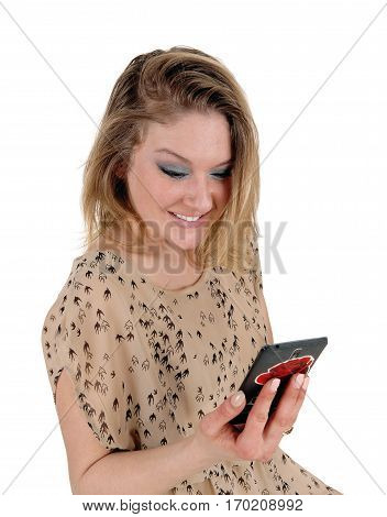 A beautiful young woman holding her cell phone smiling over the message she got isolated for white background.