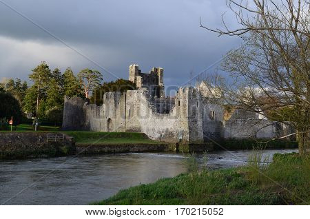 Desmond castle ruins with dark storm clouds swirling above it.