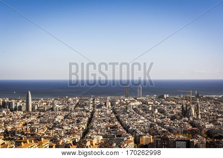 View of Barcelona, the Mediterranean sea, The tower Agbar on the left, the twin towers in the center and The Sagrada Familia Basilica on the right side.