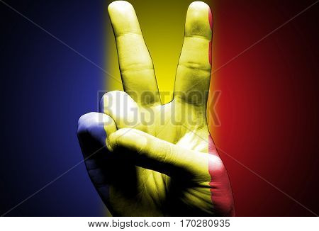 v sign hand painted with romanian flag over the romania flag black